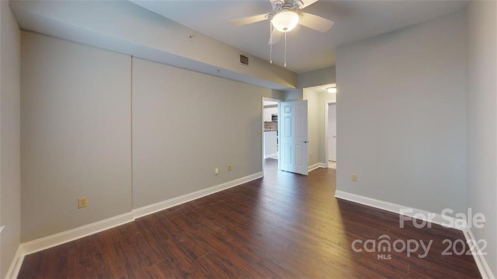 300 West 5th Street, Unit 339 Charlotte, NC 28202 - Photo 22 of 40 a view of an empty room with wooden floor