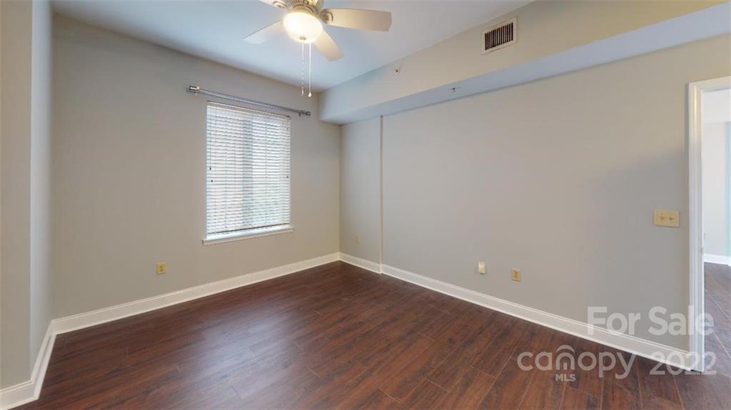 300 West 5th Street, Unit 339 Charlotte, NC 28202 - Photo 23 of 40 an empty room with wooden floor and windows