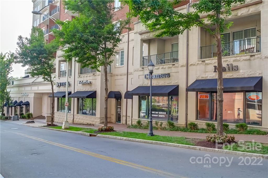 300 West 5th Street, Unit 339 Charlotte, NC 28202 - Photo 27 of 40 a view of a brick building next to a yard