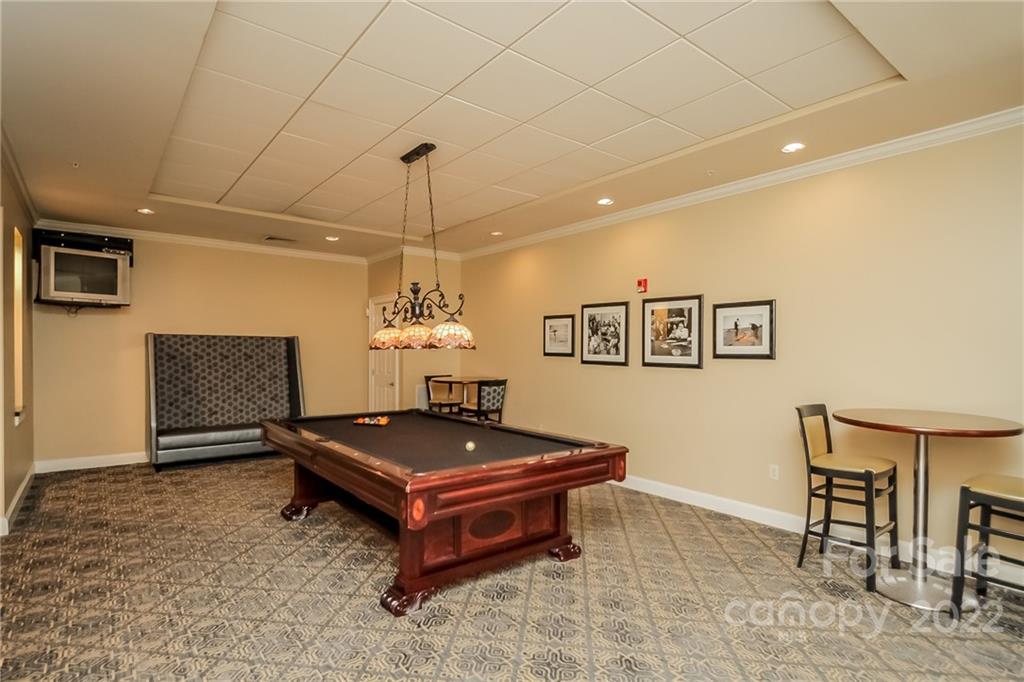 300 West 5th Street, Unit 339 Charlotte, NC 28202 - Photo 37 of 40 a living room with a table chairs and a chandelier