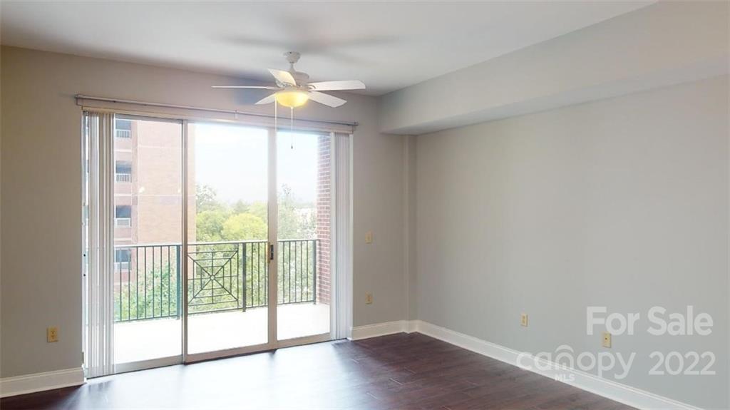 300 West 5th Street, Unit 339 Charlotte, NC 28202 - Photo 9 of 40 a view of an empty room with wooden floor and a window