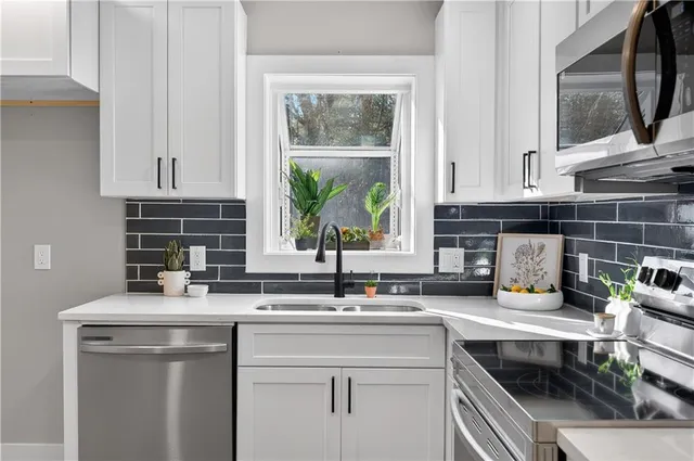 a kitchen with a sink stove and cabinets