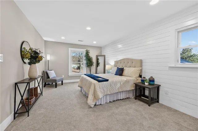 a bedroom with bed and a chandelier