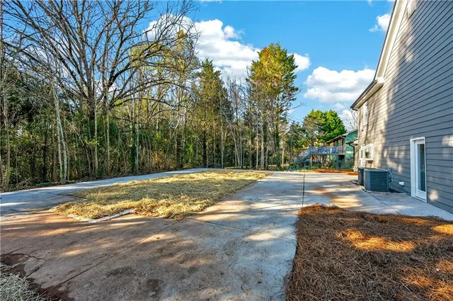 a view of a yard with a house in the background