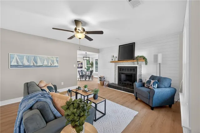a living room with furniture a flat screen tv and a fireplace
