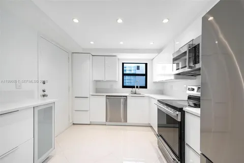 a kitchen with a sink stove top oven and cabinets