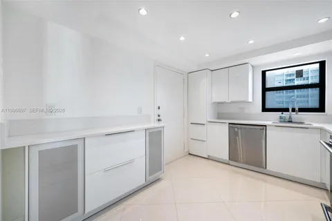 a kitchen with a sink cabinets and wooden floor