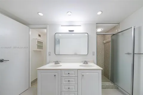 a bathroom with a sink vanity and mirror
