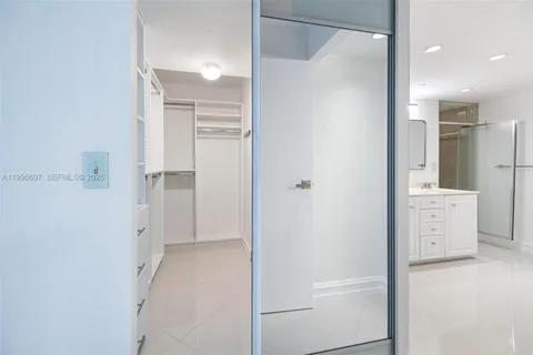 a view of walk in closet with empty racks