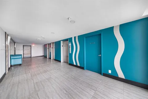 a view of a room with wooden floor and entryway