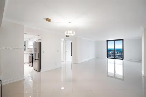 a view of a kitchen with a refrigerator and window