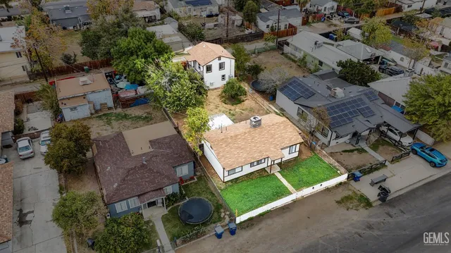 an aerial view of a house with a yard