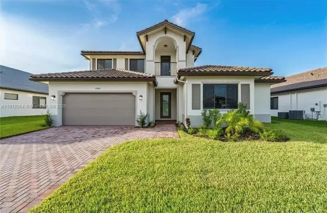 a front view of a house with a yard and garage