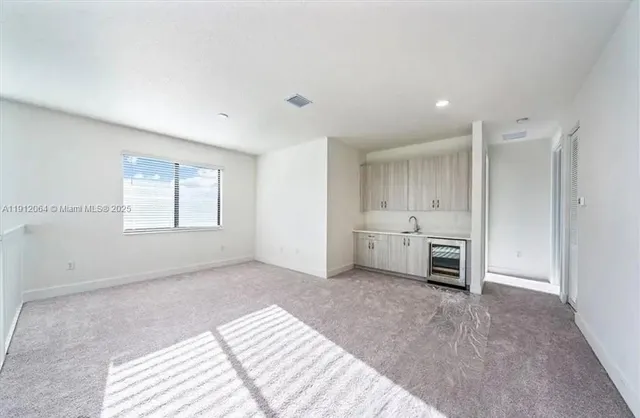 a view of a livingroom with a kitchen