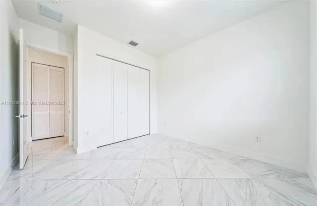 an empty room with white walls