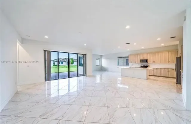 a view of a kitchen with a sink and cabinets