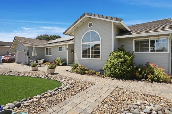 a front view of a house with garden