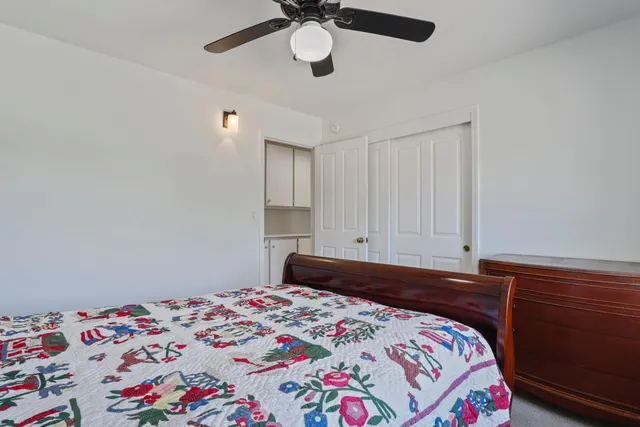 a bedroom with a bed and cabinets