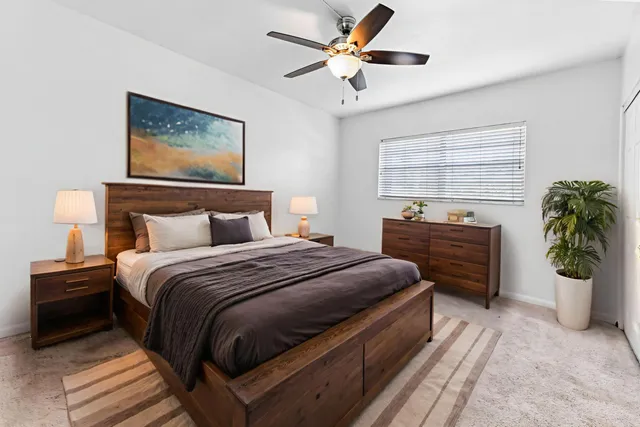 a spacious bedroom with a bed and a chandelier