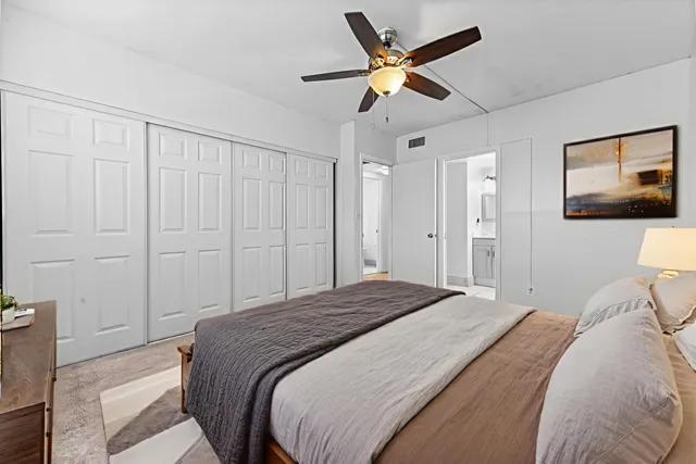 a bedroom with a large bed and a chandelier