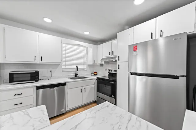 a white refrigerator freezer sitting in a kitchen