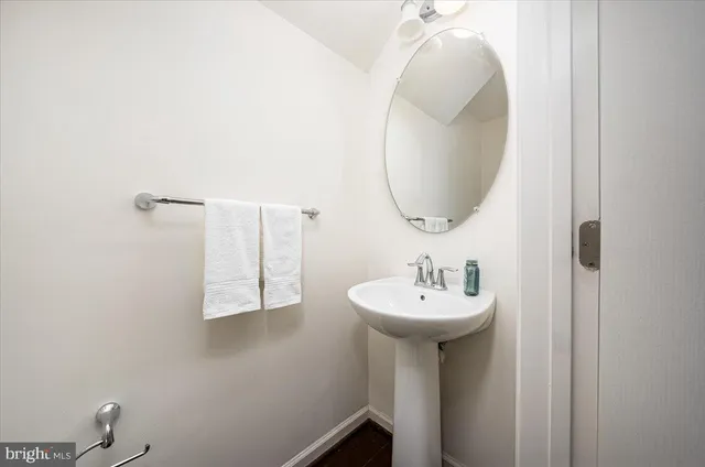 a bathroom with a sink a mirror and a toilet