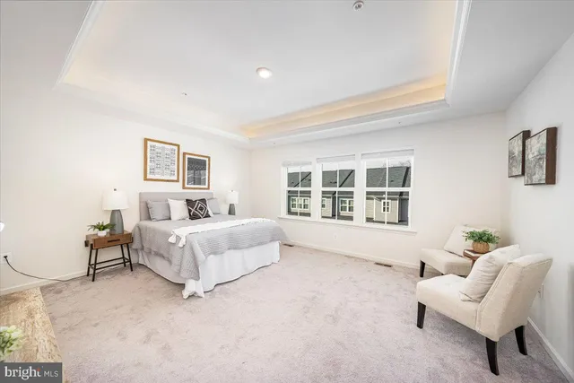 a spacious bedroom with a bed and a large window