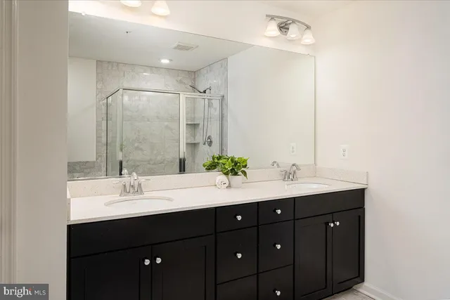 a bathroom with a double vanity sink and a mirror