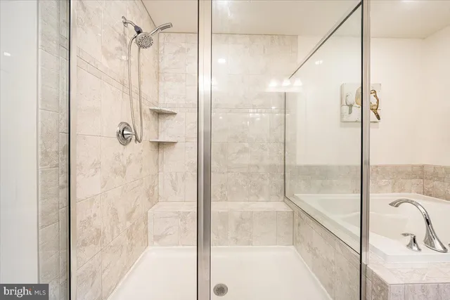 a bathroom with a glass shower door and a window