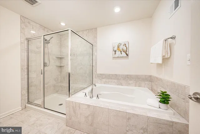 a spacious bathroom with a bathtub and a shower