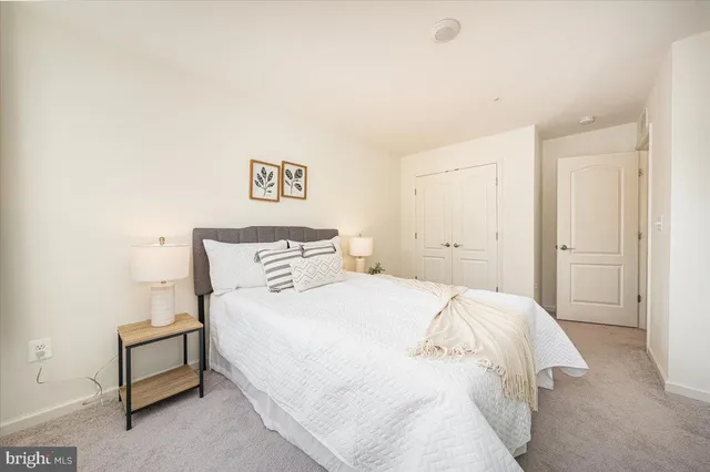 a bedroom with a bed and a lamp