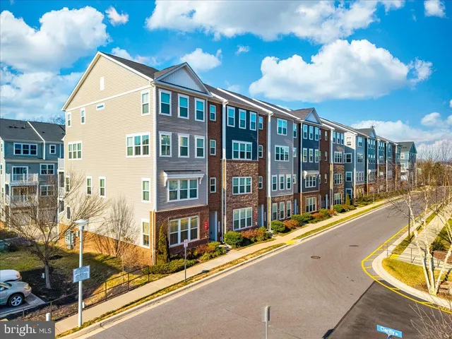 an aerial view of a swimming pool with outdoor seating