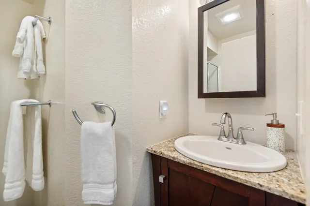 a bathroom with a sink toilet and mirror