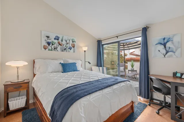 a bedroom with a bed and a desk