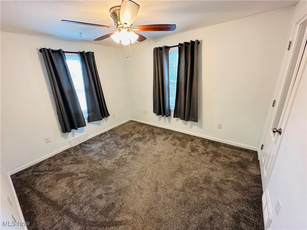 3727 Hopkins Road Youngstown, OH 44511 - Photo 31 of 40 Carpeted empty room featuring ceiling fan and a textured ceiling