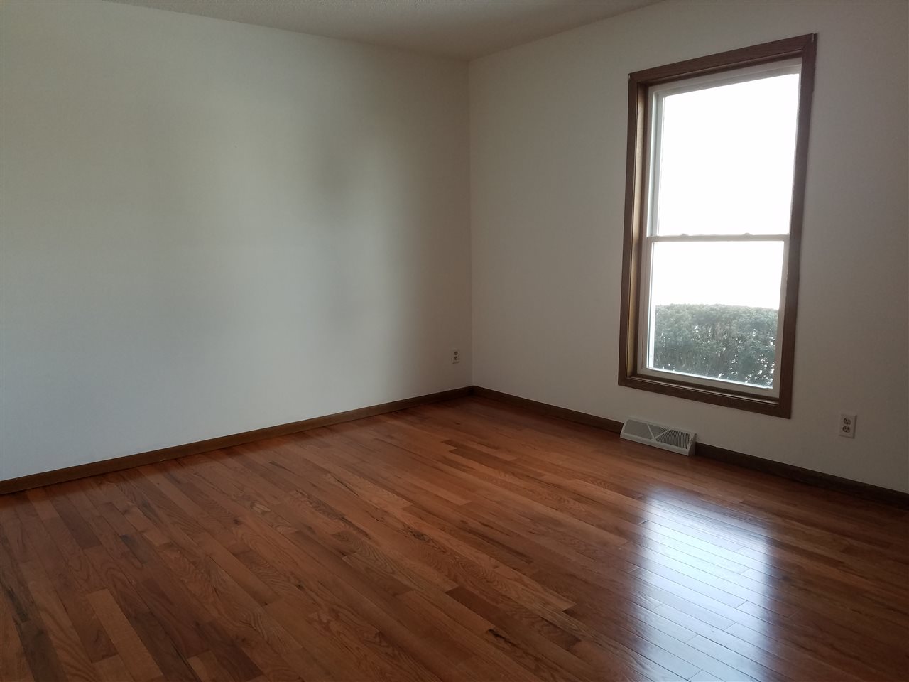 3065 East Stub Road Byron, IL 61010 - Photo 13 of 24 an empty room with wooden floor and windows