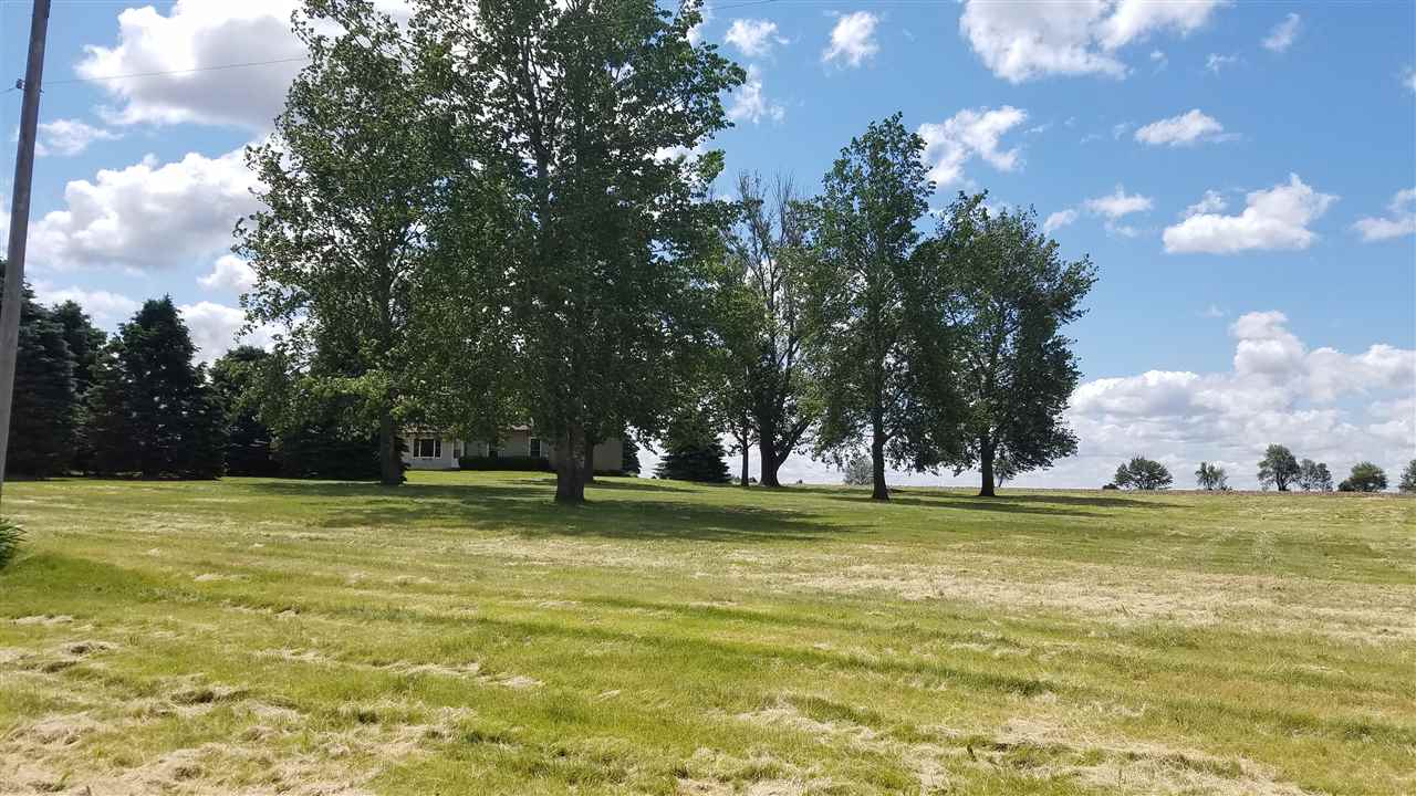 3065 East Stub Road Byron, IL 61010 - Photo 18 of 24 a view of a large swimming pool and trees in the background