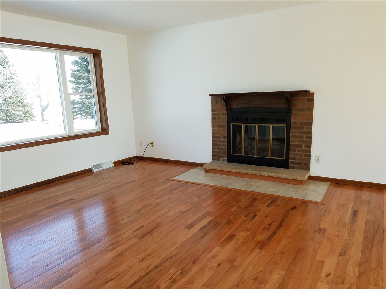 3065 East Stub Road Byron, IL 61010 - Photo 2 of 24 an empty room with wooden floor and windows
