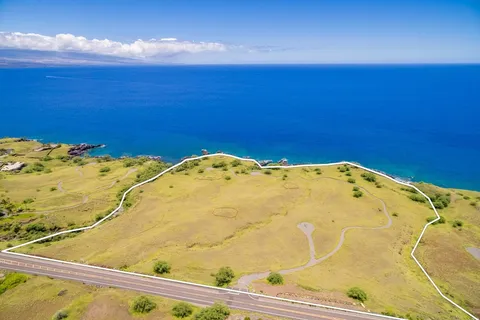 a view of a swimming pool and an ocean in the background