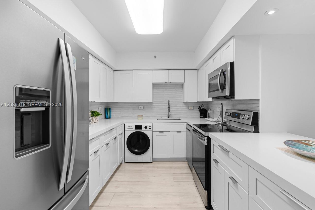 1500 Bay Road, Unit 1268S Miami Beach, FL 33139 - Photo 16 of 31 a kitchen with a refrigerator sink and stove