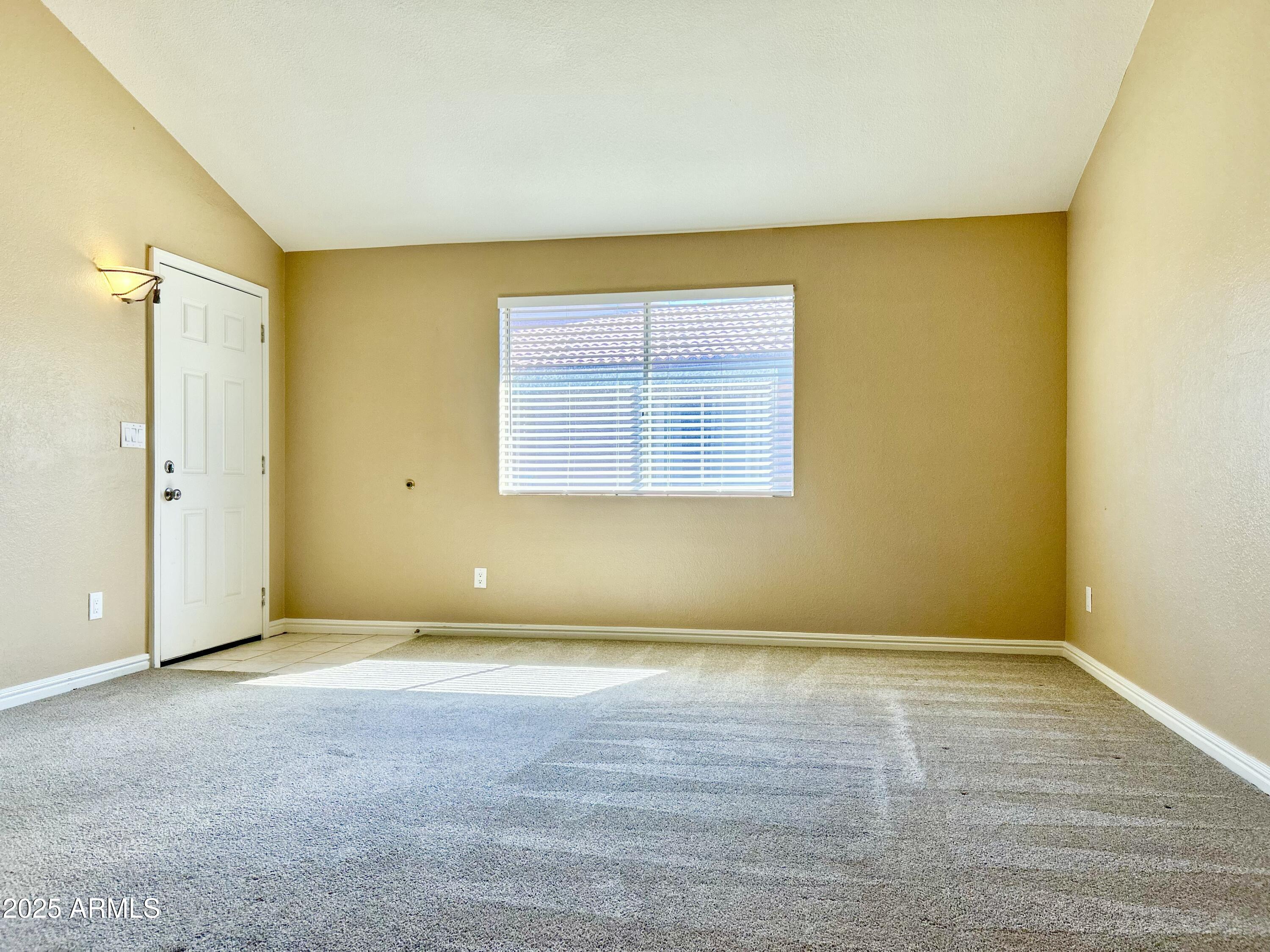 623 West Guadalupe Road, Unit 217 Mesa, AZ 85210 - Photo 2 of 12 an empty room with a empty space and a window
