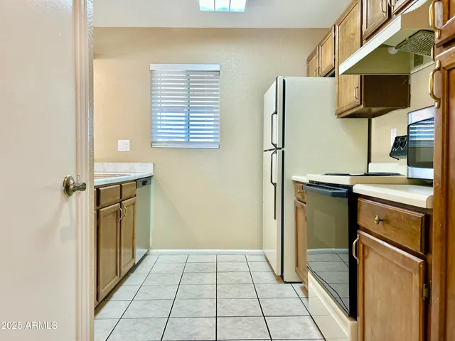 a kitchen with a refrigerator and cabinets