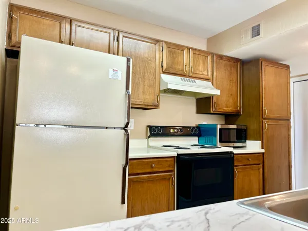 a kitchen with a refrigerator and a sink