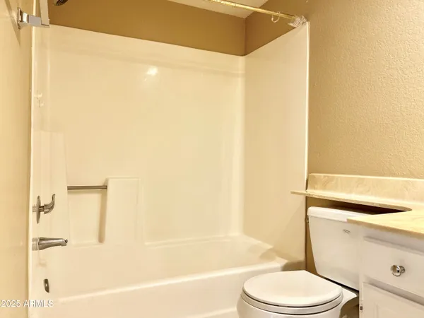 a bathroom with a bathtub and shower
