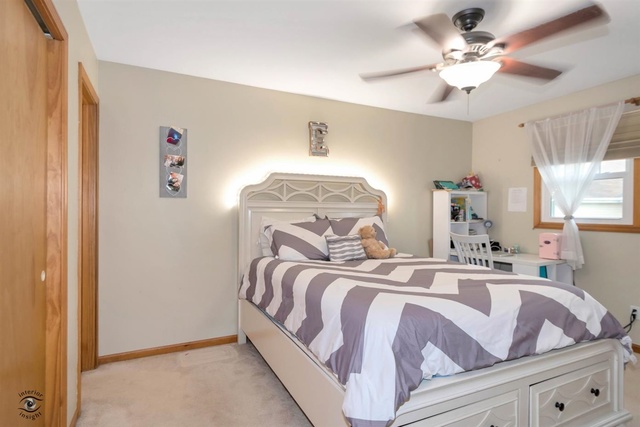784 Darsha Road New Lenox, IL 60451 - Photo 13 of 21 a bedroom with a bed and a chandelier