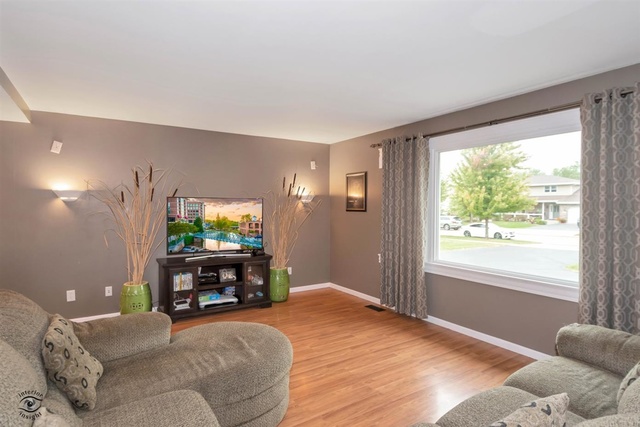 784 Darsha Road New Lenox, IL 60451 - Photo 5 of 21 a living room with furniture and a flat screen tv