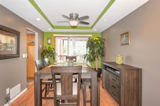 784 Darsha Road New Lenox, IL 60451 - Photo 6 of 21 a view of a dining room with furniture and a chandelier