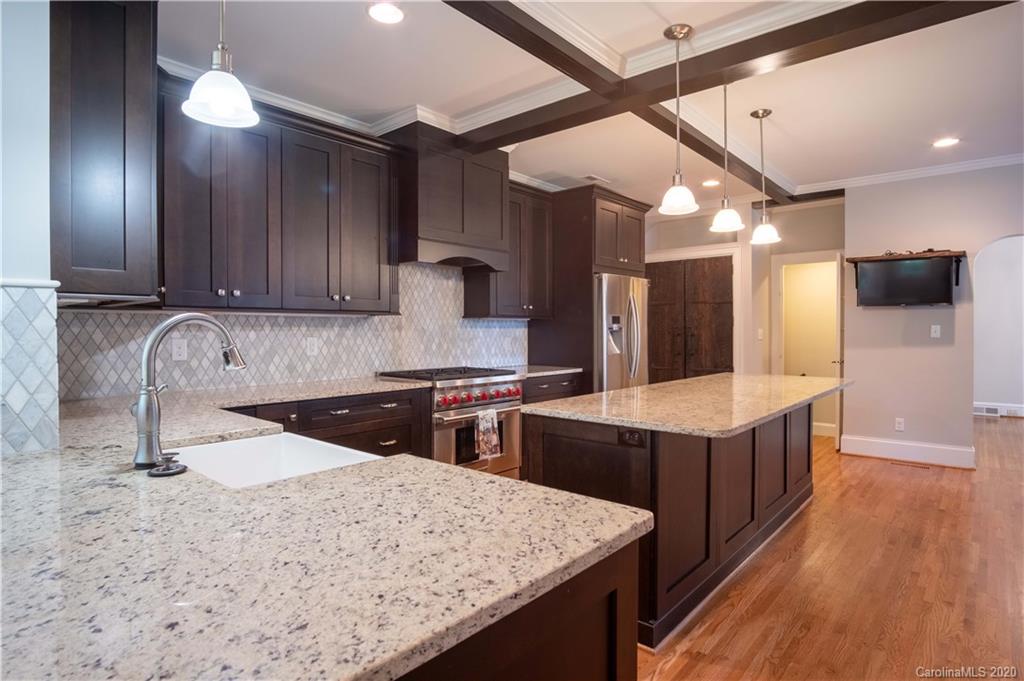 1844 Harris Road Charlotte, NC 28211 - Photo 12 of 29 a kitchen with stainless steel appliances granite countertop wooden cabinets a sink and dishwasher