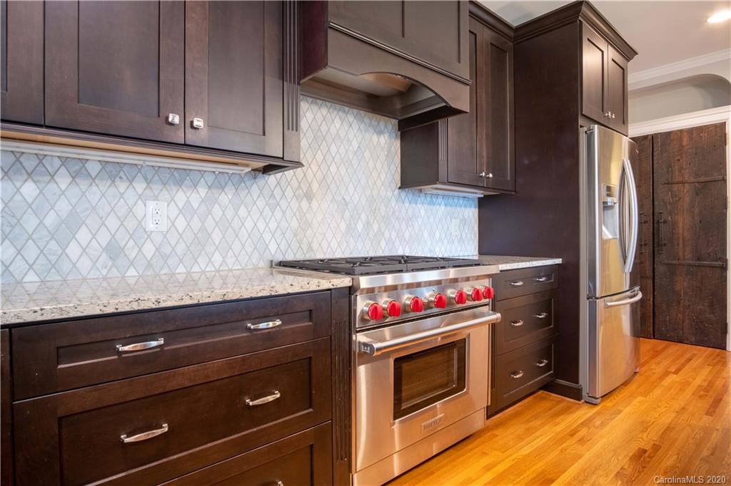 1844 Harris Road Charlotte, NC 28211 - Photo 13 of 29 a kitchen with stainless steel appliances granite countertop a stove and a refrigerator