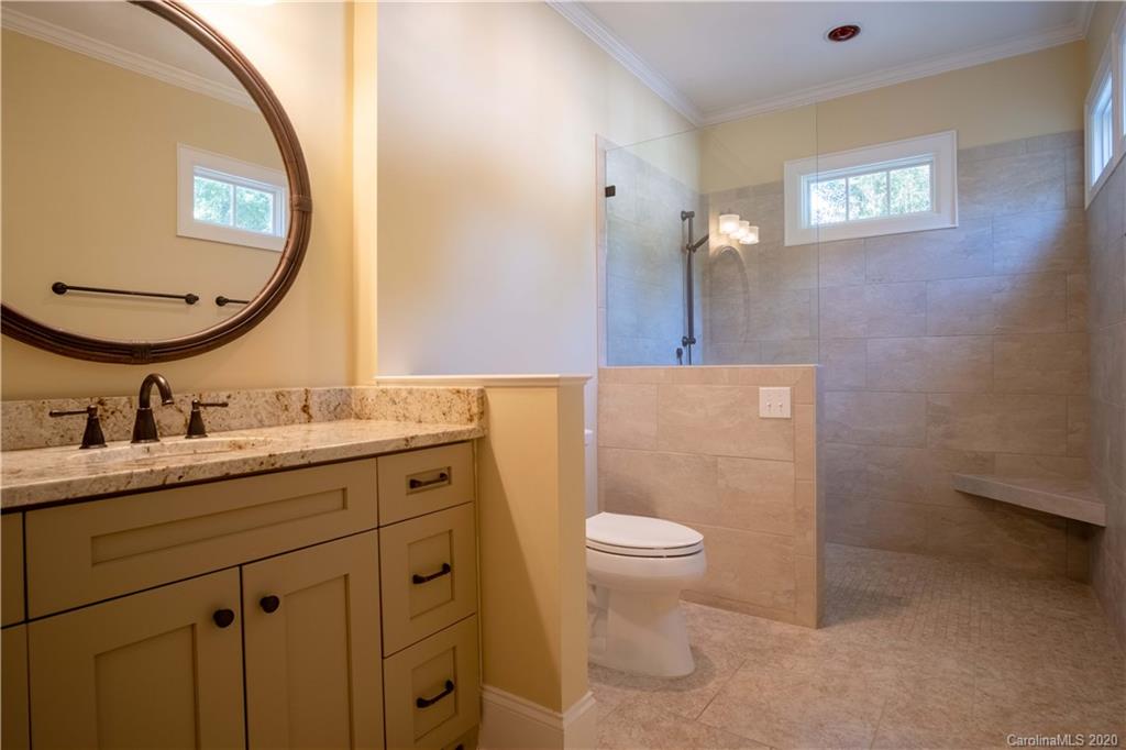 1844 Harris Road Charlotte, NC 28211 - Photo 21 of 29 a bathroom with a granite countertop sink a toilet and a mirror